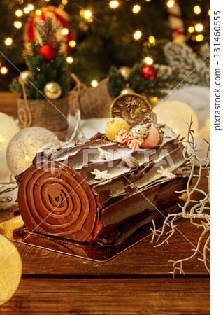 Delicious chocolate yule log cake celebrating christmas and new year's eve Delicious chocolate yule log cake celebrating christmas and new year's eve 131460855