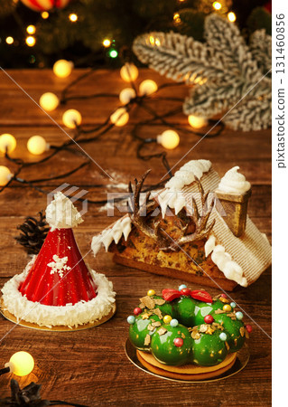 Delicious christmas mousse cakes decorated with christmas lights and ornaments 131460856