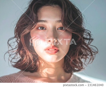 Japanese female model with light shining on her face Japanese female model with light shining on her face 131461040
