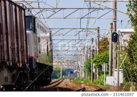 A freight train moving through a green light - JR Freight EF510 electric locomotive A freight train moving through a green light - JR Freight EF510 electric locomotive 131461097