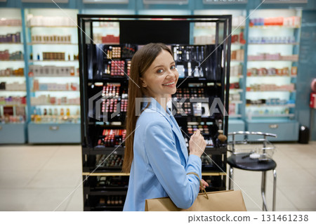 A woman wearing a blue jacket is casually walking through a pharmacy A woman wearing a blue jacket is casually walking through a pharmacy 131461238
