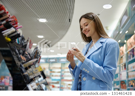 Elegant woman is focused on a stunning display of makeup products 131461428