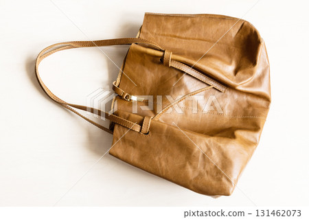 soft leather tote bag on wooden table 131462073