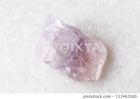 sample of uncut purple fluorite mineral on white 131462080