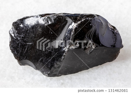 sample of raw obsidian mineral on white marble sample of raw obsidian mineral on white marble 131462081