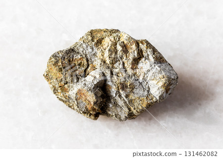 sample of unworked pyrite rock on white marble 131462082
