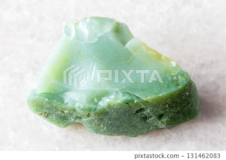 sample of raw chrysoprase rock on white marble 131462083