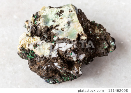 raw tenorite mineral with chrysocolla on white 131462098