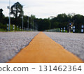 Asphalt road surface with yellow line, Surface grunge rough of asphalt, Dark grey with yellow line on the road and small rock, Texture Background, Top view 131462364