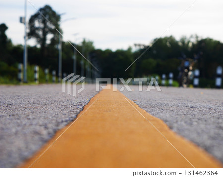 Asphalt road surface with yellow line, Surface grunge rough of asphalt, Dark grey with yellow line on the road and small rock, Texture Background, Top view 131462364
