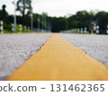 Asphalt road surface with yellow line, Surface grunge rough of asphalt, Dark grey with yellow line on the road and small rock, Texture Background, Top view 131462365