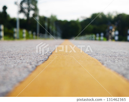 Asphalt road surface with yellow line, Surface grunge rough of asphalt, Dark grey with yellow line on the road and small rock, Texture Background, Top view 131462365