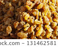 A heap of raisins. A pile of yellow raisins. A dried fruit background 131462581