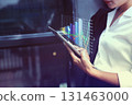 Business Woman Analyzing Financial Data on Tablet. Financial Technology (FinTech) in Use. 131463000
