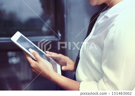 Business Woman Analyzing Financial Data on Tablet. Investment Analysis and Planning Business Woman Analyzing Financial Data on Tablet. Investment Analysis and Planning 131463002