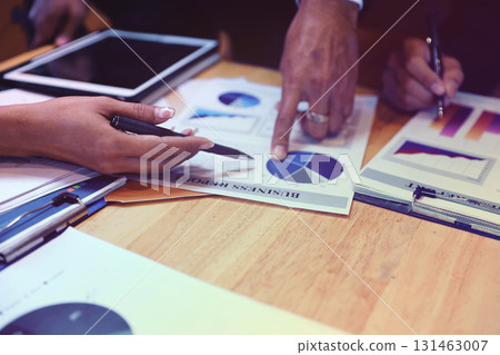 A group of business people are meeting to analyze data for marketing plan A group of business people are meeting to analyze data for marketing plan 131463007