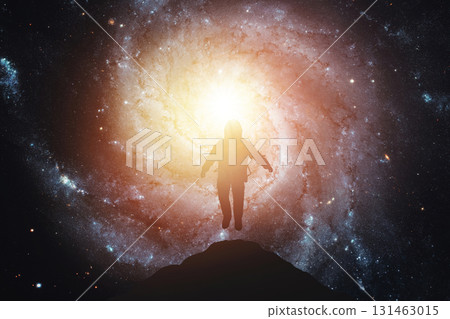 Silhouette of an astronaut levitating against the background of the galaxy. Elements of this image courtesy of NASA 131463015