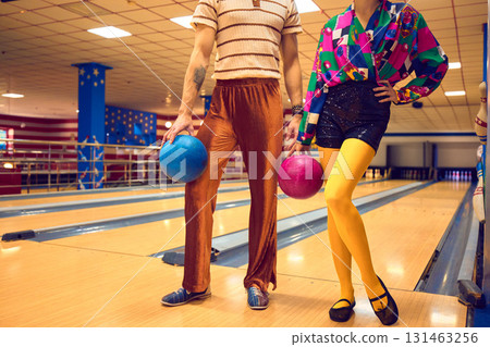 Man and woman holding bowling balls in vibrant retro style 131463256
