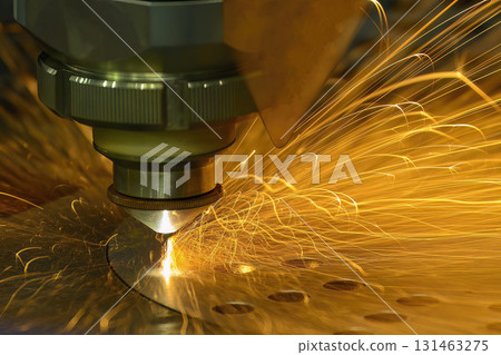 Close up scene the fiber laser cutting machine cut the metal plate control by CNC program. Close up scene the fiber laser cutting machine cut the metal plate control by CNC program. 131463275