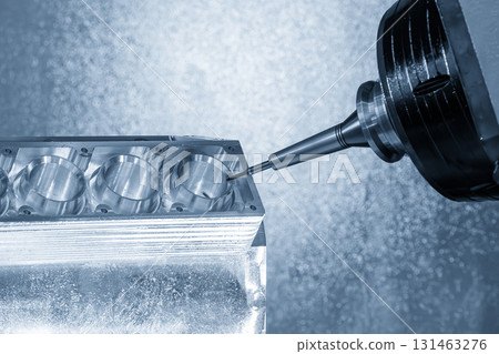 The 5-axis CNC milling machine cutting the aluminum engine block by solid ball nose end mill tool in the light blue scene. 131463276