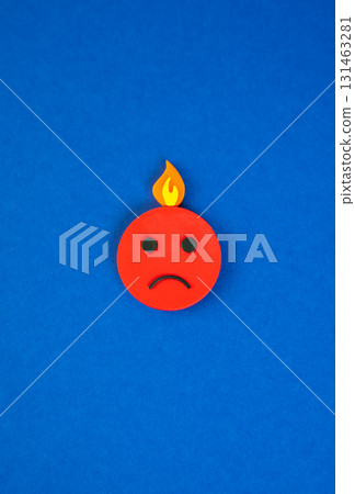 An angry face with fire on its head. Severe burnout. Doubts and fears, uncertainty and complexes, stress. Mental health symbol, emotional overload, life challenges. 131463281