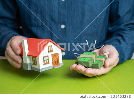 A man buys a house and puts down cash as collateral. Property appraisal. Rent and the rental business. Concept for real estate, mortgages, investment, family housing, credit and legal contracts. 131463288
