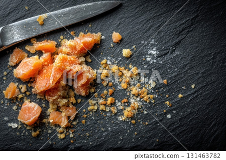 Salmon candy on slate with crumbs and knife, authentic preparation style Salmon candy on slate with crumbs and knife, authentic preparation style 131463782