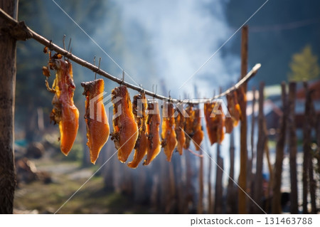 Traditional northern indigenous candied salmon hanging to dry 131463788