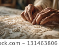 Hands embroidering intricate floral patterns 131463806