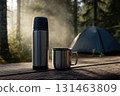 Morning scene with thermos and mug on table 131463809