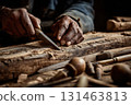 Hands carving wood with traditional tools, focused on craft 131463813