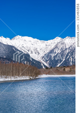 Taisho Pond, snow-covered Mount Okuhotaka and Tsuri Ridge, winter trekking in Kamikochi, Matsumoto City, Nagano Prefecture 131463858