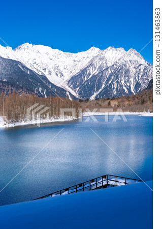 Taisho Pond, snow-covered Mount Okuhotaka and Tsuri Ridge, winter trekking in Kamikochi, Matsumoto City, Nagano Prefecture 131463863