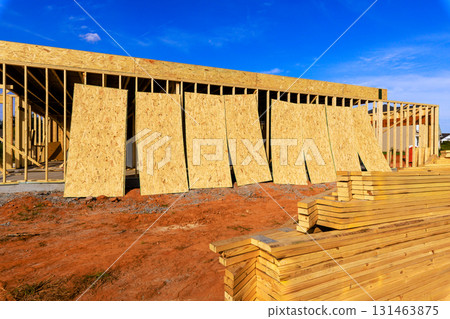 Workers prepare wooden plywood panels framing for construction, progress during frame works Workers prepare wooden plywood panels framing for construction, progress during frame works 131463875