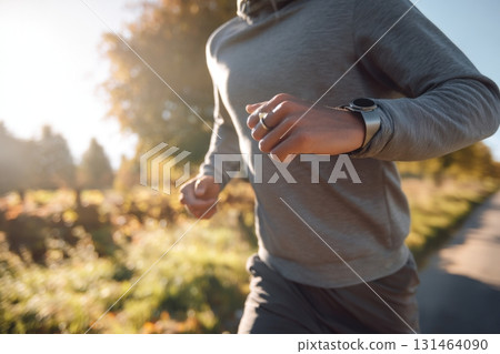 Man jogging outdoors with smart ring fitness tech 131464090