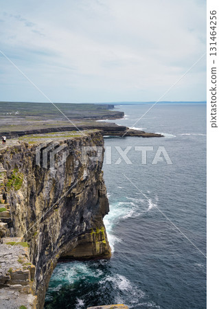 Dramatic view of rugged cliffs meeting the vast ocean in the beautiful landscape of Ireland. Dramatic view of rugged cliffs meeting the vast ocean in the beautiful landscape of Ireland. 131464256