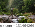Active Man Hiker Trekking through River Valley 131464269