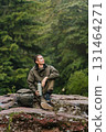 Hiker Sitting on Rock Enjoying Moment of Rest 131464271