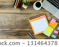 Organized flat lay of planner and office supplies on a wooden desk 131464378