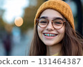 Smiling teen showing colorful braces during school break 131464387