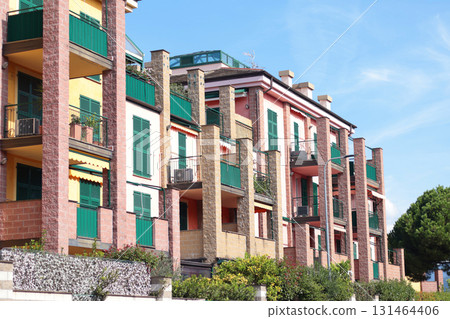 Street with houses in Italian village, Liguria. Modern architecture building in Genoa of 2000s. Nature and sky. Street with houses in Italian village, Liguria. Modern architecture building in Genoa of 2000s. Nature and sky. 131464406