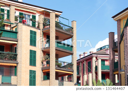Street with houses in Italian village, Liguria. Modern architecture building in Genoa of 2000s. Nature and sky.  131464407