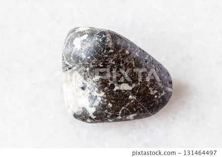 sample of tumbled trachybasalt mineral on white sample of tumbled trachybasalt mineral on white 131464497