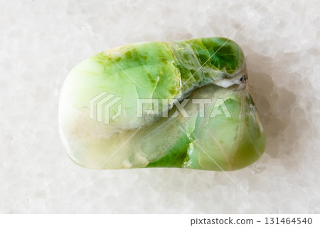 sample of tumbled green opalite mineral on white sample of tumbled green opalite mineral on white 131464540