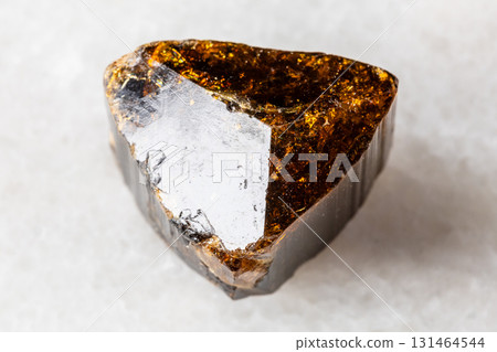 sample of raw dravite tourmaline mineral on white 131464544