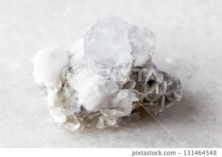 colorless beryl with mica, feldspar rock on white colorless beryl with mica, feldspar rock on white 131464548