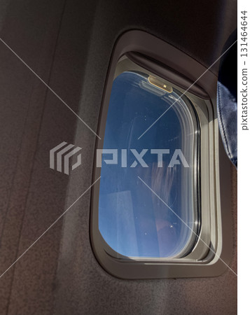 Serene airplane window view reveals a vast clear blue sky, symbolizing travel, journey, freedom, and the peaceful experience of aerial flight Serene airplane window view reveals a vast clear blue sky, symbolizing travel, journey, freedom, and the peaceful experience of aerial flight 131464644