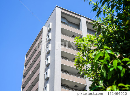 A modern condominium that stands out against the blue sky 131464920
