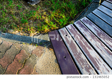 Old wood with peeling paint and the ground of the park Old wood with peeling paint and the ground of the park 131465052