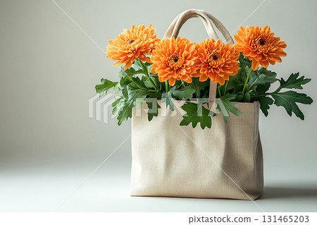Reusable shopping bag made of fabric with a bouquet of chrysanthemums on a white background. 131465203